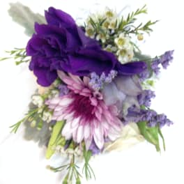 Purple and pink floral corsage with small white blossoms