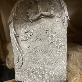Silver memorial plaque with angel and floral relief reading "In Loving Memory"