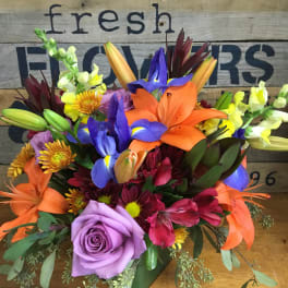 Colorful mixed bouquet with lilies, iris, roses, and snapdragons