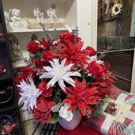 Red and white floral arrangement in a ribbed vase