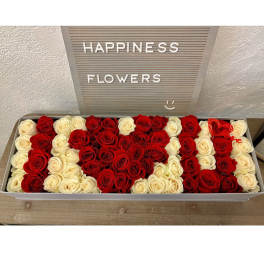 Box of red and white roses arranged in a heart shape