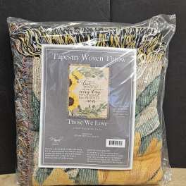 Packaged woven throw blanket with a sunflower and memorial message