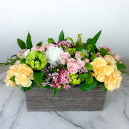 Mixed pastel flower arrangement in a rectangular wooden box
