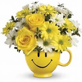 Yellow flower bouquet in a smiley-face mug