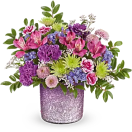 Mixed bouquet in a glittery purple vase with pink, purple, and green flowers