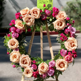 Heart-shaped rose wreath on a wooden easel