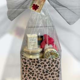 Gift basket with candles and bath items in leopard-print packaging