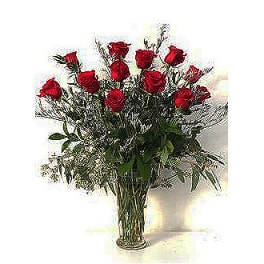Tall bouquet of red roses in a clear glass vase
