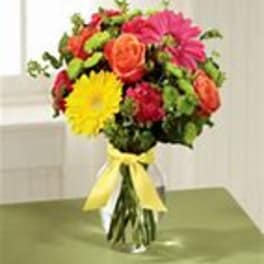 Colorful bouquet of mixed flowers tied with a yellow ribbon