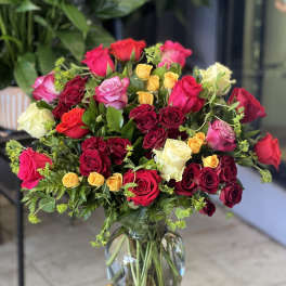 Mixed roses in a clear glass vase