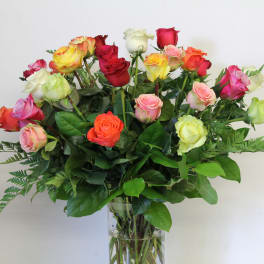 Mixed-color roses arranged in a clear glass vase
