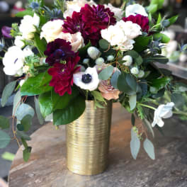 Bouquet of burgundy, white, and blush flowers in a gold vase