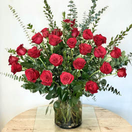 Tall bouquet of red roses in a glass vase
