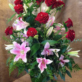 Red roses and pink lilies in a glass vase