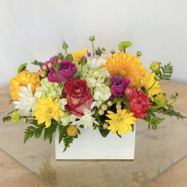 Mixed bouquet in a white rectangular box with yellow, pink, and white flowers