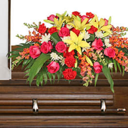 Colorful floral spray on a wooden casket