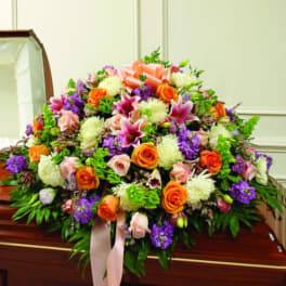 Large casket spray with orange, pink, purple, and white flowers