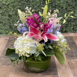 Pink lilies and hydrangeas in a green vase