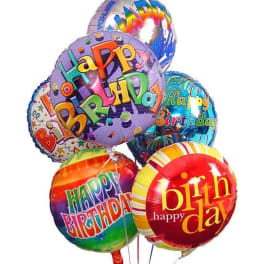 Cluster of colorful round Happy Birthday foil balloons