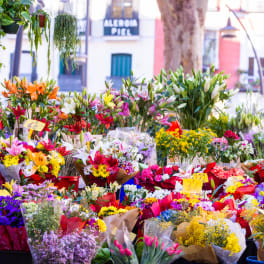 Outdoor flower market with colorful bouquets in buckets