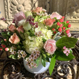 Pink and white rose bouquet in a white vase