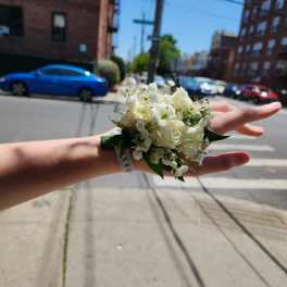Small white rose wrist corsage with baby's breath