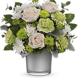 White and green flower arrangement in a clear glass vase