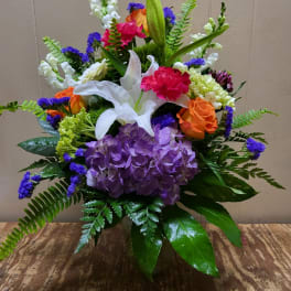 Colorful bouquet with lilies, roses, hydrangea, and snapdragons in a vase