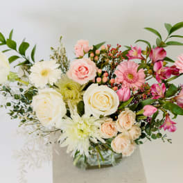 Mixed bouquet of pink and white flowers in a vase