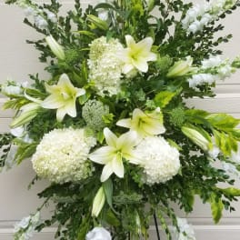 White lilies and hydrangeas in a large standing spray