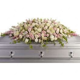 Pastel floral spray on a silver casket