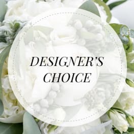 White floral arrangement with a "Designer’s Choice" label