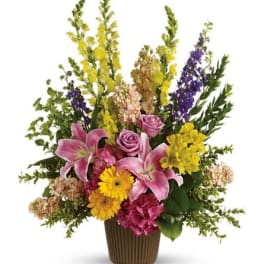 Mixed bouquet in a brown vase with pink lilies and yellow flowers