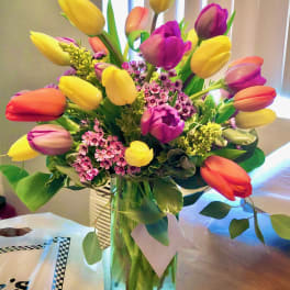 Colorful tulip bouquet in a clear glass vase