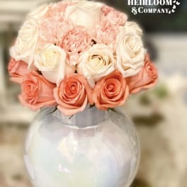 Pink and white rose bouquet in a clear round vase