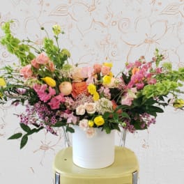 Colorful mixed flower arrangement in a white vase