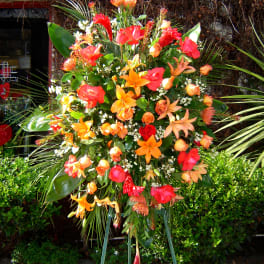 Large tropical standing spray with orange and red flowers