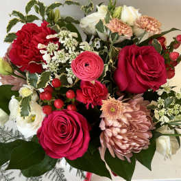 Bouquet of red and white roses with pink chrysanthemums and berries