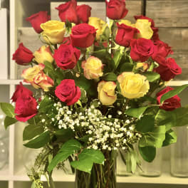 Bouquet of red and yellow roses in a glass vase