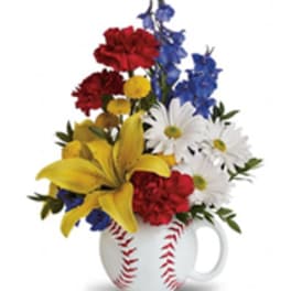 Mixed flowers arranged in a baseball-shaped mug