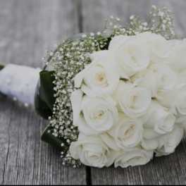 White rose bouquet with baby's breath wrapped in white ribbon