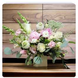 Pink and white floral arrangement in a square vase