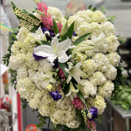 Large standing floral spray with white lilies and cream hydrangeas