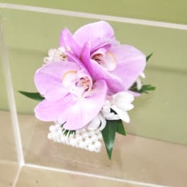 Pink orchid corsage with white accents and pearl trim