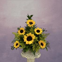 Sunflower arrangement in a decorative pedestal vase