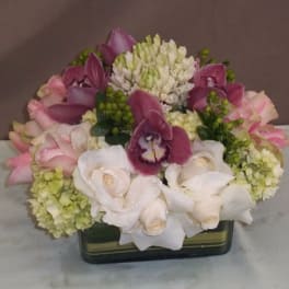 Pink and white floral arrangement in a rectangular vase