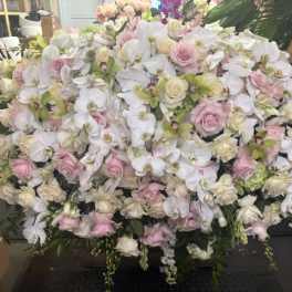 Large arrangement of white orchids and pale pink roses