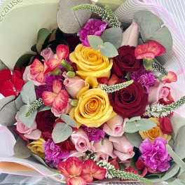 Bouquet of roses, carnations, and pink flowers with eucalyptus