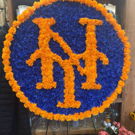 Round floral sign with orange letters on a blue flower background