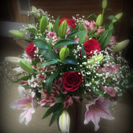 Bouquet of red roses, pink lilies, and white baby's breath